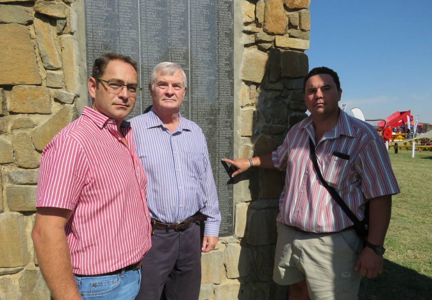 Visitors beside one of the memorial name panels